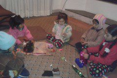 Children preparing Christmas gift packet to respected